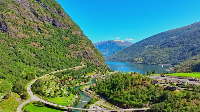 Flam Norway aerial drone skyline view of green valley, river, farms and village on sunny summer day