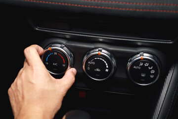 close up hand  open air conditioning system button inside a car. concept transport travel.