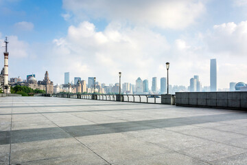 Obraz premium Modern Urban Skyline with Empty Plaza and Street Lamps