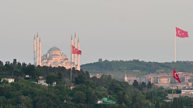 Istanbul,turkey,august 4, 2025. Grand camlica mosque on a green hill in istanbul, turkey. Turkish flags fluttering in the wind against the backdrop of the city's skyline