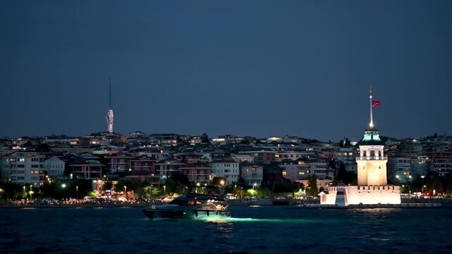 Istanbul,turkey,august 4, 2025. Scenic night view of istanbul featuring the illuminated maiden's tower and a boat sailing on the bosphorus, with the city skyline lit up