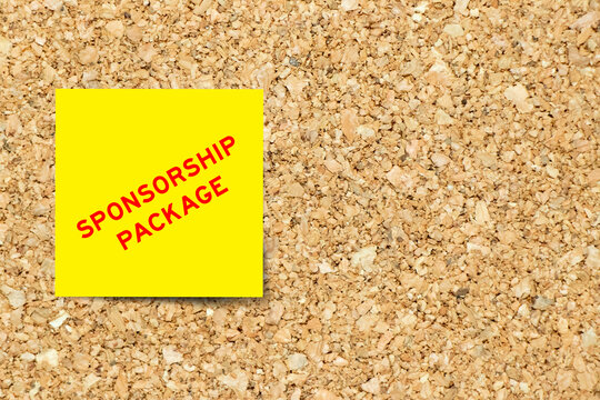 Yellow note paper with word sponsorship package on cork board background with copy space