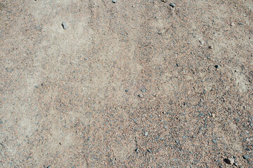Fototapeta premium Dry gravel and sand ground texture with tiny pebbles and small stones detail close up
