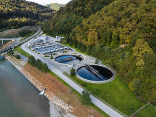 Aerial view of a modern wastewater treatment and water management facility highlighting industrial infrastructure within a green landscape.