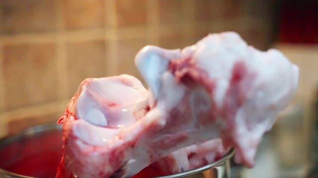 Large beef marrow bones prepared in bowl for canine raw feeding diet