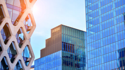 Modern office building exterior made from glass and steel. Windows of office building. Abstract architectural concept with sunlight. 