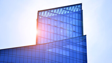 Fototapeta premium Modern office building exterior made from glass and steel. Windows of office building. Abstract architectural concept with sunlight. 