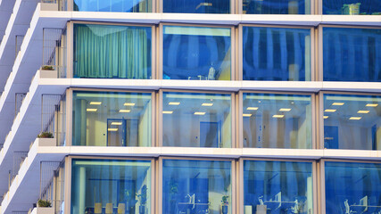 A modern tall building made of steel and glass, housing offices and financial institutions. Glass...