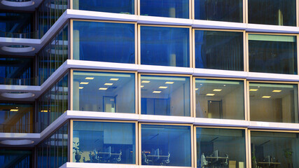 A modern tall building made of steel and glass, housing offices and financial institutions. Glass...