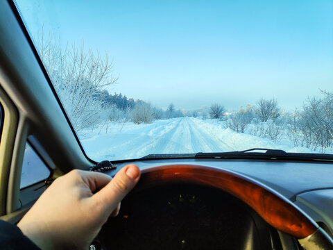 inside the car. driver behind the wheel. drive a car. journey. bad roads. by car . steering wheel and dashboard. wheels and engine.