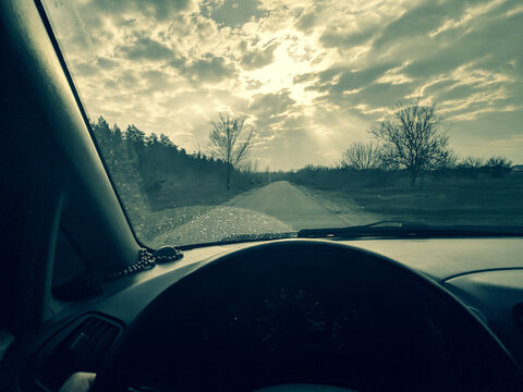 inside the car. driver behind the wheel. drive a car. journey. bad roads. by car . steering wheel and dashboard. wheels and engine.