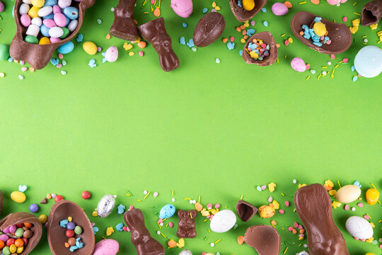 Easter egg hunting, sale and holiday traditions. Various candy and chocolate Easter eggs, bunny and rabbits on bright green background. Preparation for Easter, greeting card, Easter sale and shopping