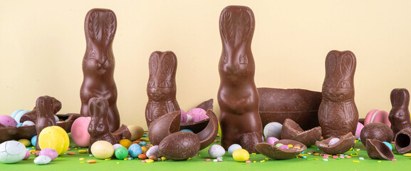 Easter egg hunting, sale and holiday traditions. Various candy and chocolate Easter eggs, bunny and...