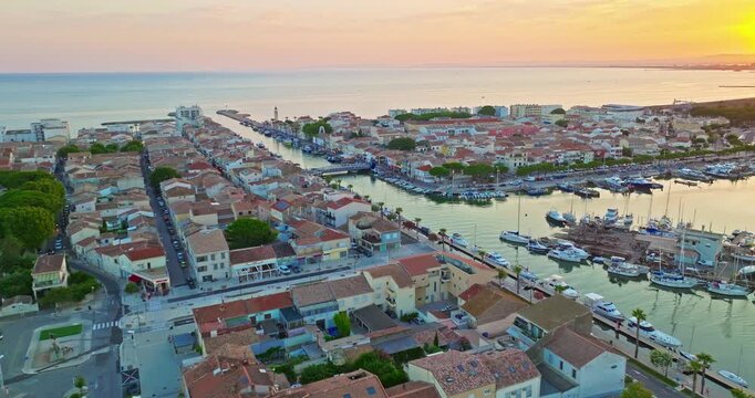 Aerial view of the Grau du Roi fishing village at sunrise in Camargue, a resort on the coast of Occitanie region in France. Beautiful coast town Grau du Roi in southern France