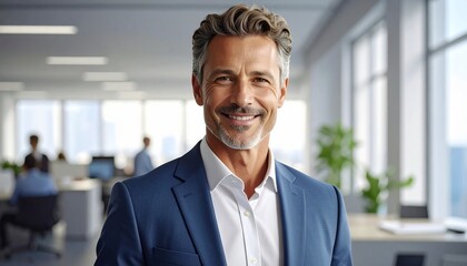 Fototapeta premium Confident middle-aged entrepreneur and company leader stands inside a professional office environment, smiling naturally toward the camera. The executive’s close-up portrait conveys leadership, succes