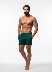 Fototapeta premium Muscular man in green short posing. Fitness and healthy lifestyle concept for sport, health, and male fashion.