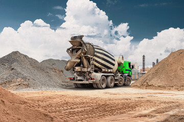 Fototapeta premium A concrete mixer truck stands at the construction site. The heavy equipment works efficiently, moving materials and supporting ongoing projects