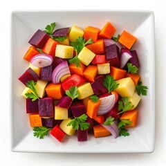 Top down view of colorful diced root vegetables and herbs on white plate