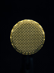 Close up of a vintage microphone on a dark studio background