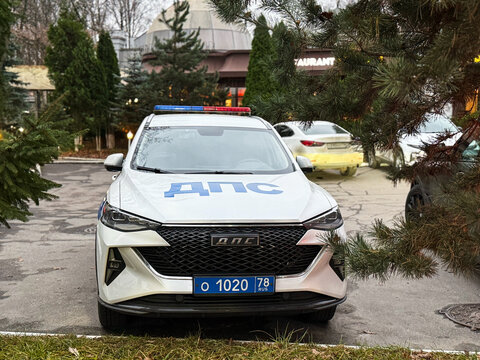 Russian DPS traffic police patrol car based on a JAC crossover parked on a city street with a visible blue police license plate.