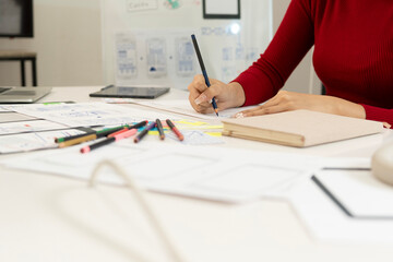 Creative web designer planning UI application and developing digital template