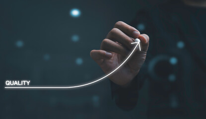 Business hand drawing upward arrow from quality baseline represent continuous improvement , performance growth by process optimization for excellence mindset and corporate quality management strategy.