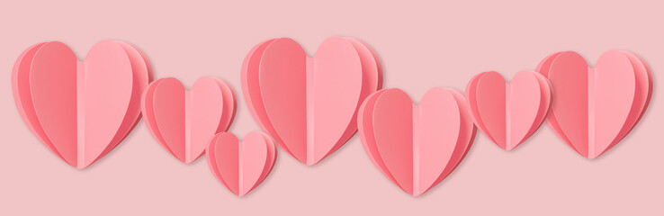 Pink paper heart in line on pink colored background. Minimal design style flat lay wide banner,...