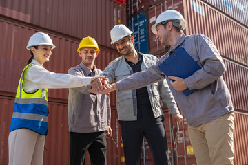Diverse group engineers team warehouse shipping container join hands to work success at at freight cargo yard