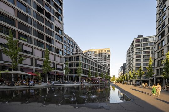 Office building, fountains and restaurants on Europaallee, in the evening light, Zurich, Switzerland