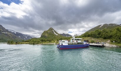 Boat at the jetty, end point of the traverse of the Besseggen Ridge, Lake Gjende, Jotunheimen National Park, Vågå, Innlandet, Norway