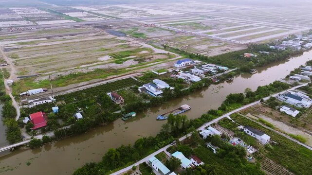 Aerial Drone View of Sand Carrier Ship Transporting Raw Materials on River in Vietnam
The vessel is heavily loaded with dredged sand, destined for local construction and infrastructure projects