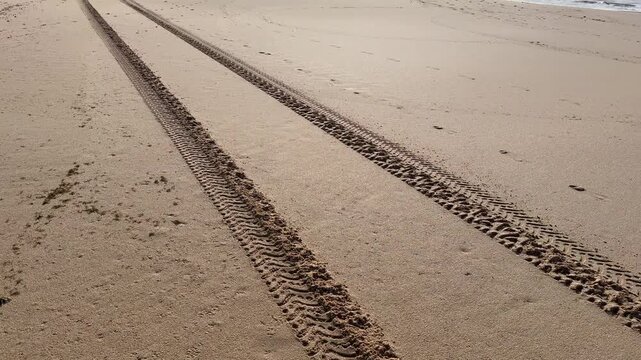 tire tracks in beach road 