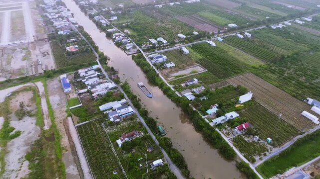 Aerial Drone View of Sand Carrier Ship Transporting Raw Materials on River in Vietnam
The vessel is heavily loaded with dredged sand, destined for local construction and infrastructure projects