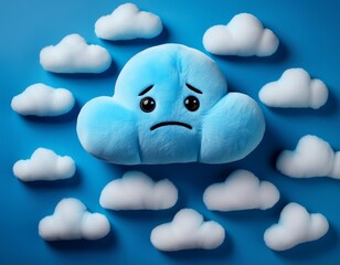 Top view of blue sad plush toy in shape of a cloud on blue background with many others clouds. Blue  monday concept