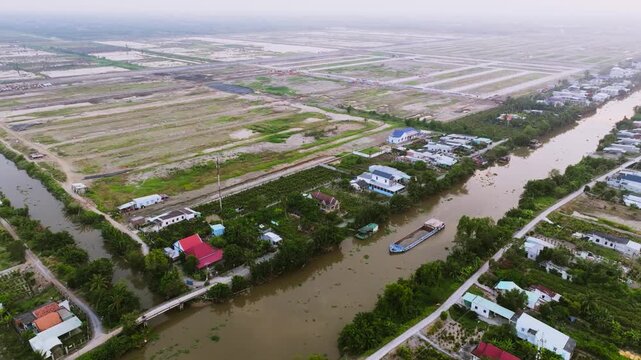 Aerial Drone View of Sand Carrier Ship Transporting Raw Materials on River in Vietnam
The vessel is heavily loaded with dredged sand, destined for local construction and infrastructure projects