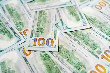 Obraz premium American bills of 100 US dollars are laid out on the surface and occupy the entire area of ​​the image, the background is made of American dollars, greenbacks of large denominations