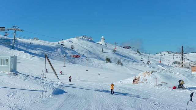 Jahorina, Bosnia and Herzegovina &ndash; January 17, 2026: Lower and wider aerial view of gondola line, ski slopes, and skiers
