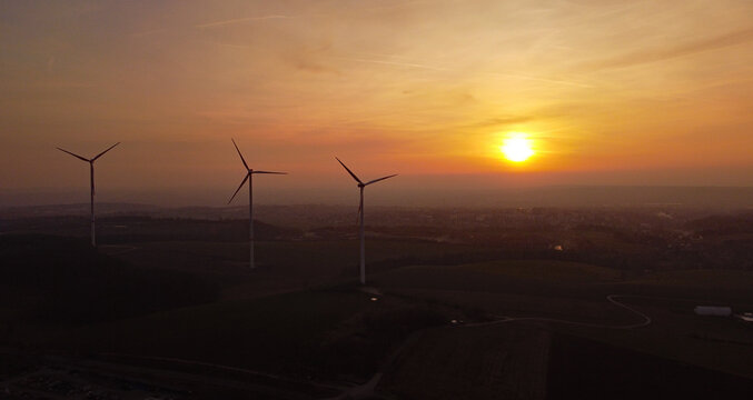 wonderful views of wind turbines in the evening glow with the setting sun