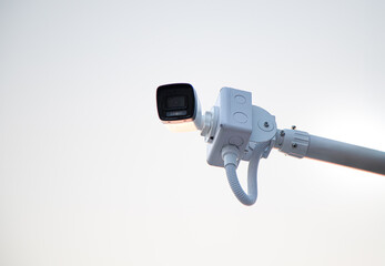 Online Security CCTV camera surveillance system outdoor of house. A blurred night city scape background. Real time Modern CCTV camera on a wall. Equipment system service for safety life or asset.