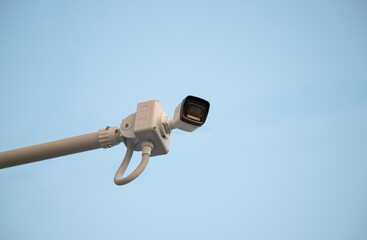 Online Security CCTV camera surveillance system outdoor of house. A blurred night city scape background. Real time Modern CCTV camera on a wall. Equipment system service for safety life or asset.