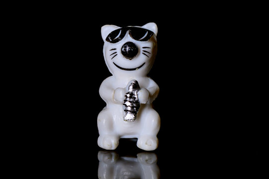 Novi Sad, Serbia - January 03, 2026: The item is likely a collectible or figurine of a Maneki-neko (beckoning cat). This type of figurine is a common Japanese talisman, often believed to bring good lu