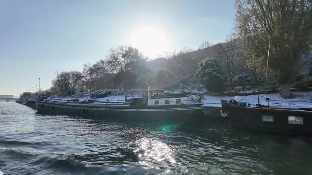 Houseboats on the Seine river during sunny winter morning