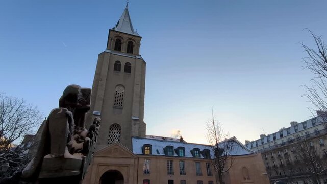 Historic Saint Germain church covered in snow at sunrise