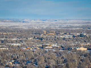 Fototapeta premium winter morning over city of Fort Collins and Front Range of Rocky Mountains in northern Colorado after snowstorm, aerial view