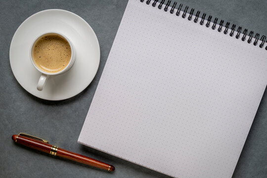 blank spiral notebook with grid paper, flat lay with coffee on textured art paper - Powered by Adobe