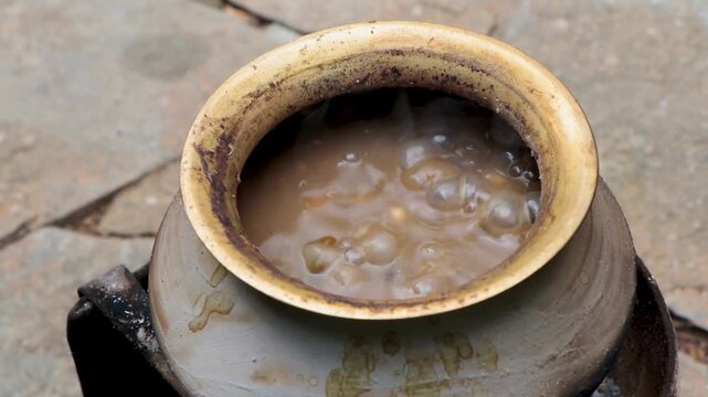 Village style dal makhni made from black gram and kidney beans slow cooked on an open wood fire, showing traditional food, patience, and rural Indian lifestyle.