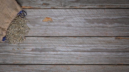 Rustic Wooden Background With Open Sack Of Green Arabica Coffee Beans
