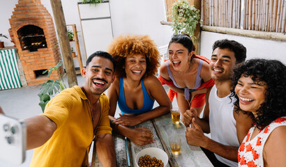 Group of five friends taking a selfie at outdoor gathering in Rio de Janeiro