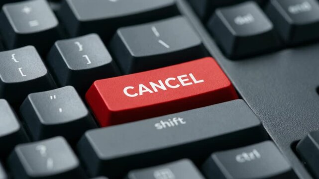 Close-up of a computer keyboard with a prominent red cancel key for modern technology themes