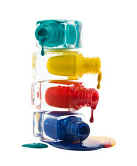 Pyramid of nail polish bottles isolated on white background.